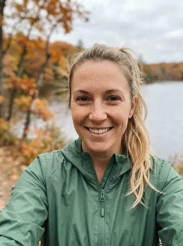 Lakeside selfie of the woman in a green windbreaker