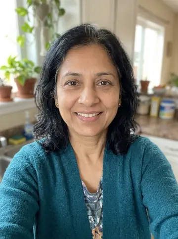 Kitchen selfie of the mother in a teal cardigan