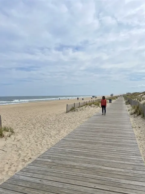 Bad photo for a Crazy Frog AI video: a person standing far away on a boardwalk